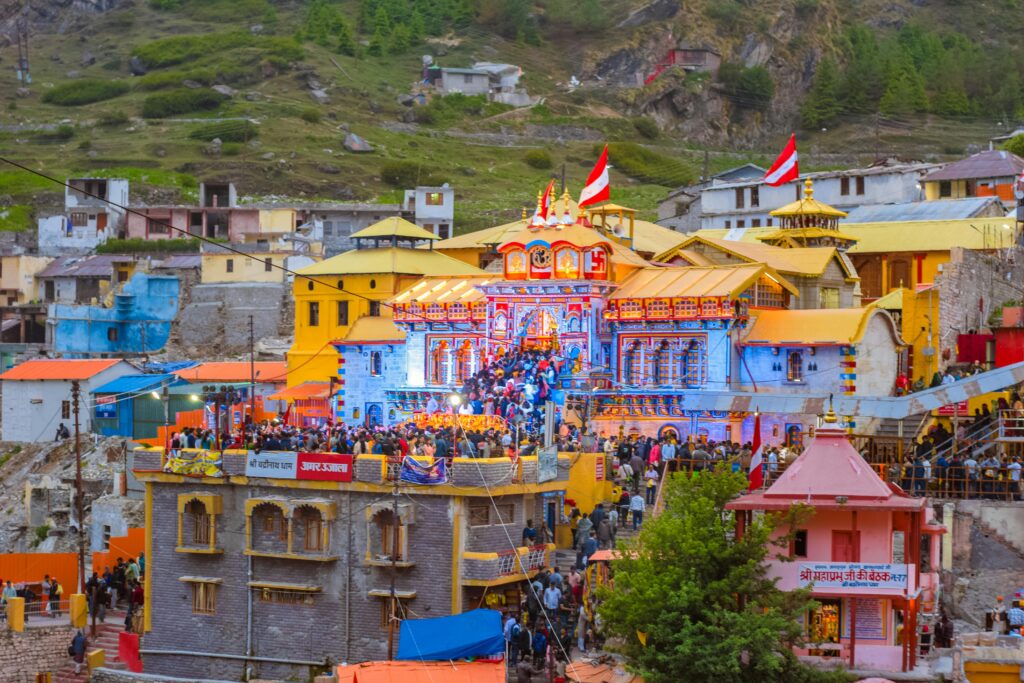 Colorful view of Badrinath Temple, bustling with activity and visitors in Uttarakhand, India.