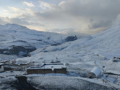 A breathtaking view of the snow-covered mountains and valley in Chicham, Himachal Pradesh, India.