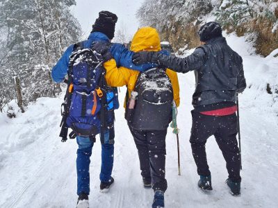 Group of friends hiking in snowy winter landscape in Sosan, India.